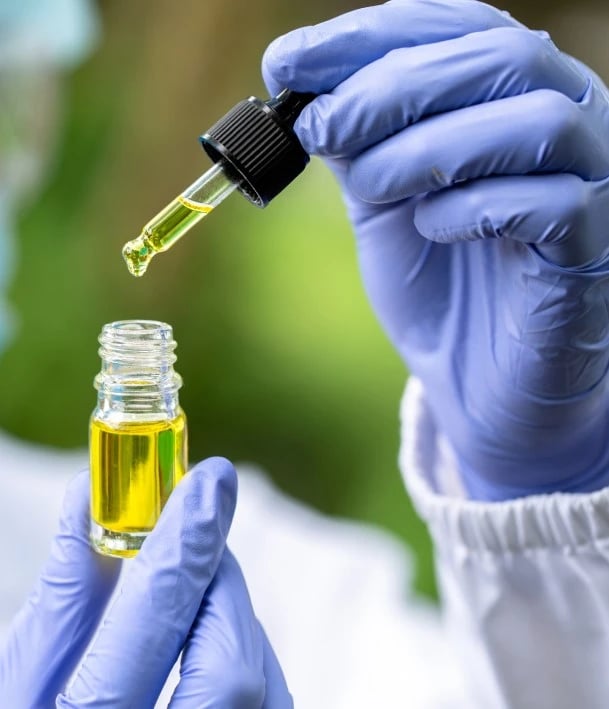 scientist holding cannabis oil for testing