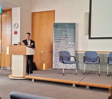 Chris presenting on stage