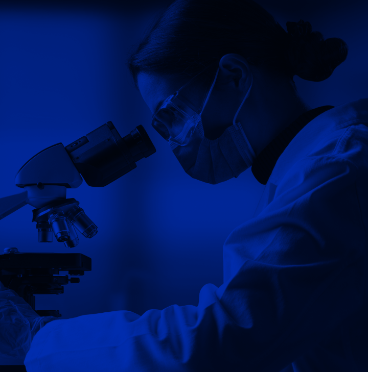 scientist-looking-through-microscope-blue