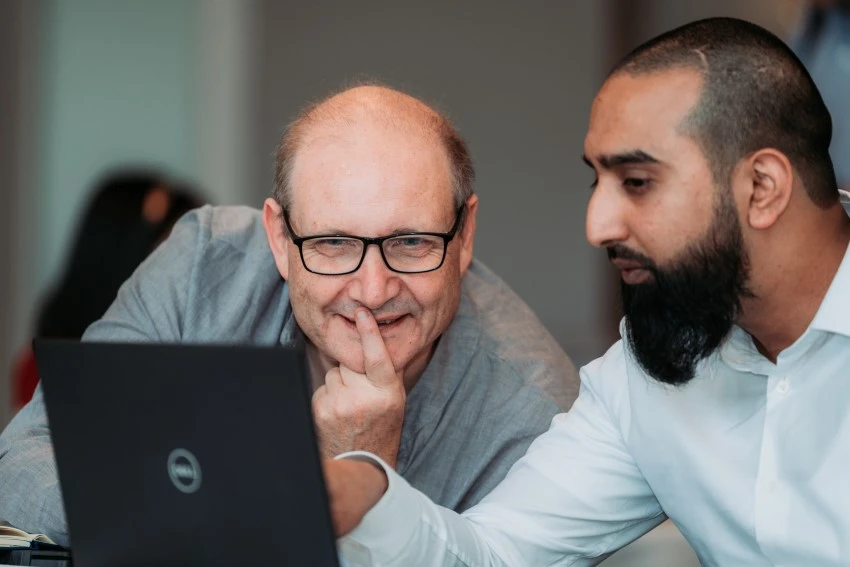 Two Broughton cannabinoid consultants working together at a computer