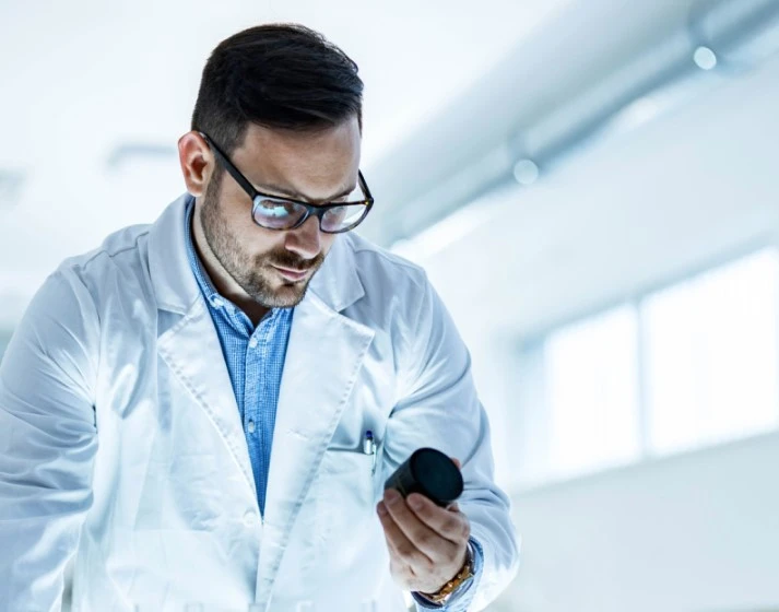 Male Scientist holding a product